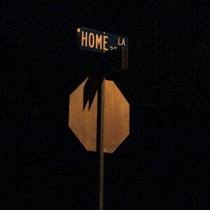 Picture of a street sign that reads "Home"
