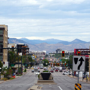The Rocky Mountains come into your home with this Denver Streets canvas print. This photograph shows an intersection near Civic Center Park in downtown Denver, with the Rocky Mountains in the background.